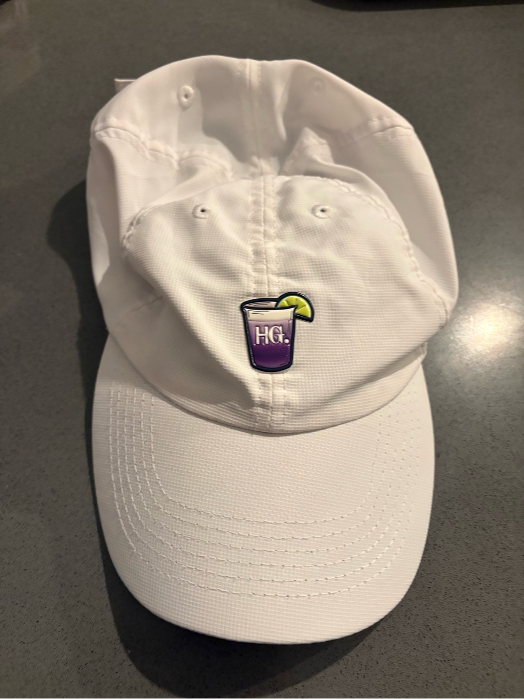 White Baseball Cap With Purple Logo